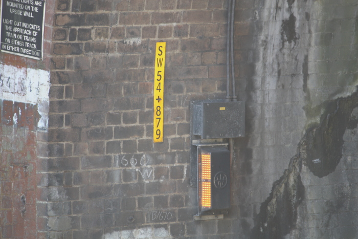 The safety lighting and kilometrage sign at the southern portal of the tunnel.