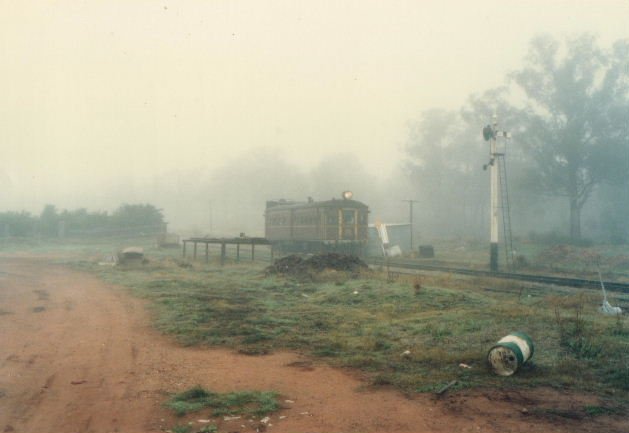 The view looking up the line as a diesel railmotor approaches the yard.