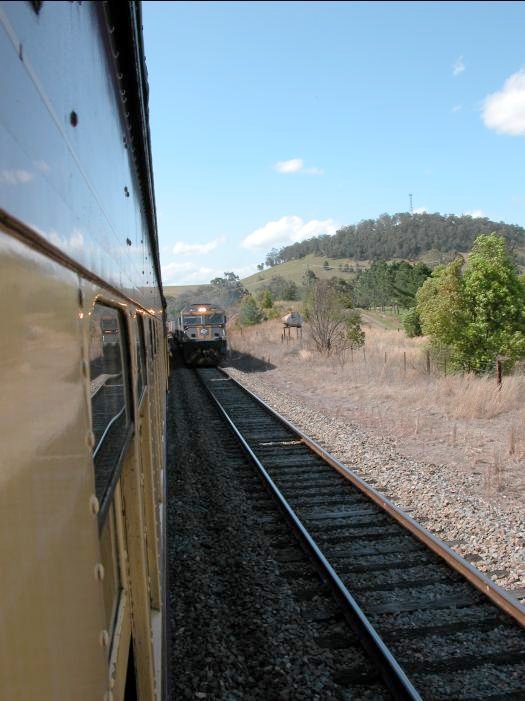 A tour train and a Brisbane-bound freighter cross in the loop at Berrico.