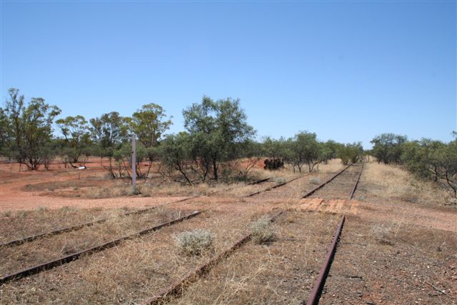 The view looking across the yard showing a level crossing and loading bank.