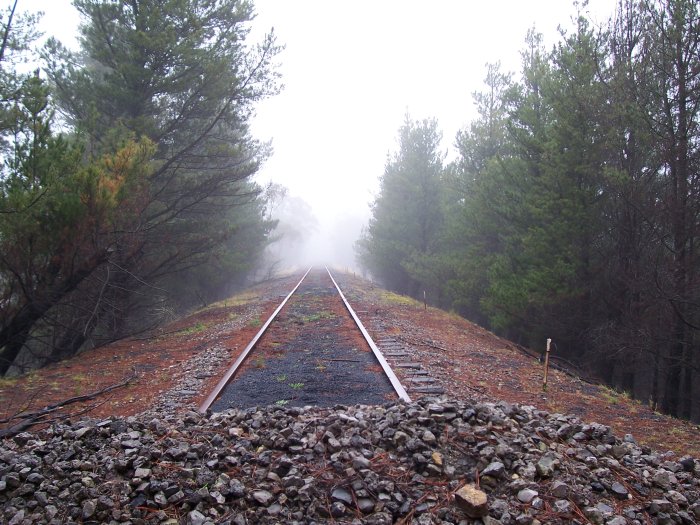 The branch line ends along the top of an embankment.