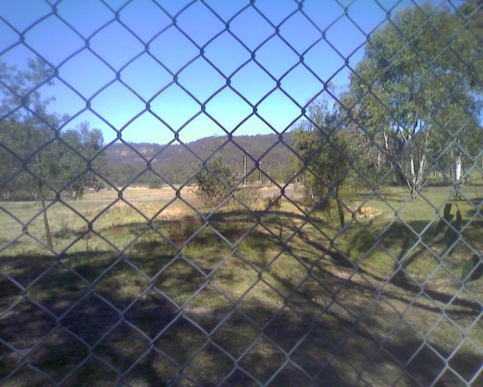 The view looking through the security fence towards ther platform.