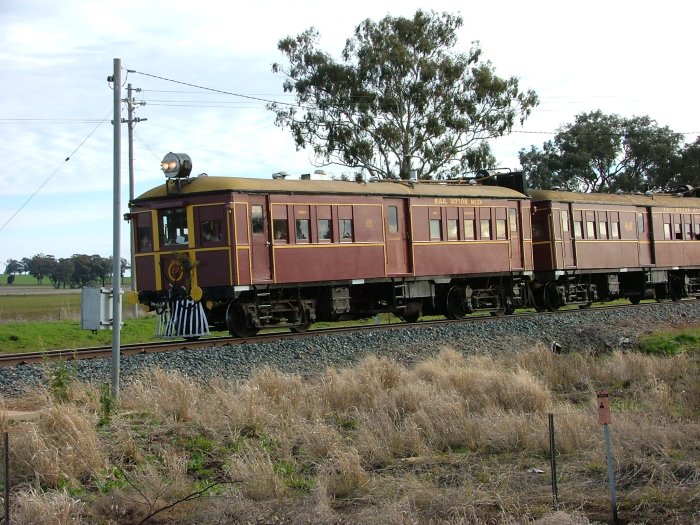 A preserves rail-motor set on a tour passes through the station.