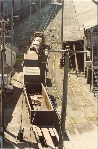 
A locomotive (possibly a 73 class) hauls some wagons through the yard.
