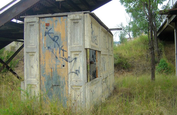 The remains of the pre-cast concrete electrical hut under the footbridge.