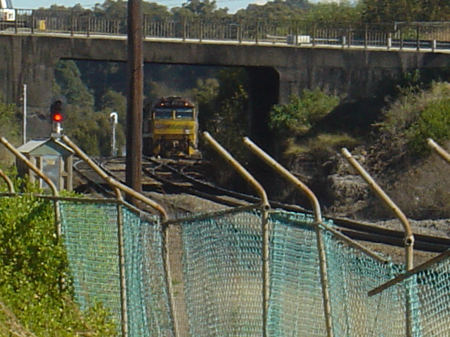 A QR National train waiting for the road before heading north.