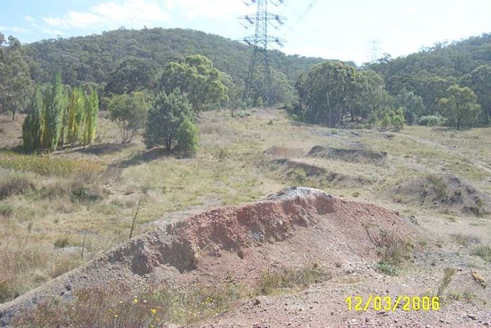 From the top of the embankment, the line passed across the gap and finished approx at the base of the tranmission tower.