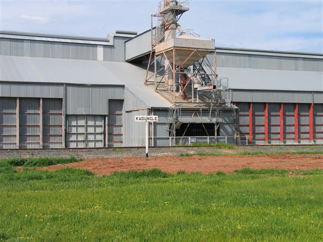 A close-up of the silo, with the station's signpost sitting opposite.