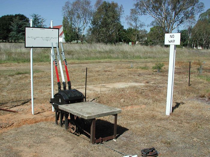 
The A Frame adjacent to the station building, south side. Only one of the
levers still work, it's visible with the chain attached. It operates the
signal on the north end of the yard.
