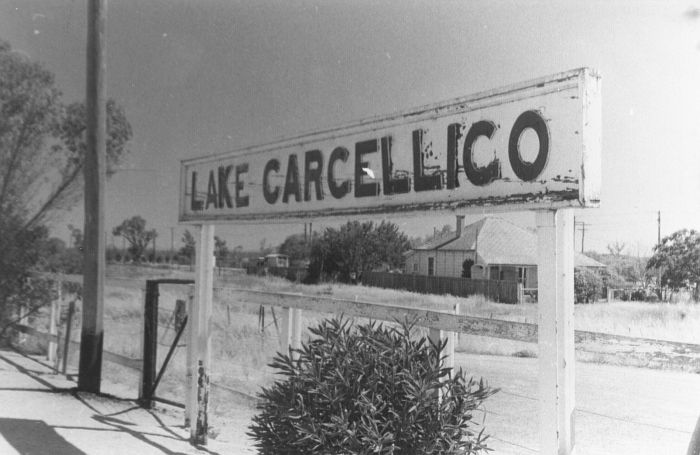 
The flaking wooden nameboard sits on the platform.
