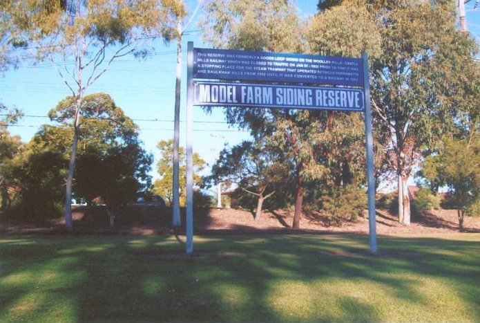 A sign giving information about the siding. Windsor Road is in the background.