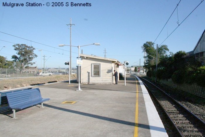 Photo shows Mulgrave Station and Signal Box, with current Station Manager locking door. The signal box currently houses CCTV equipment, but has been nearly destroyed by whiteants and is in a sorry state of repair inside.