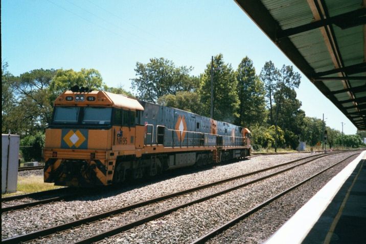 
A pair on National Rail locos sit idle in a siding opposite the platform.
