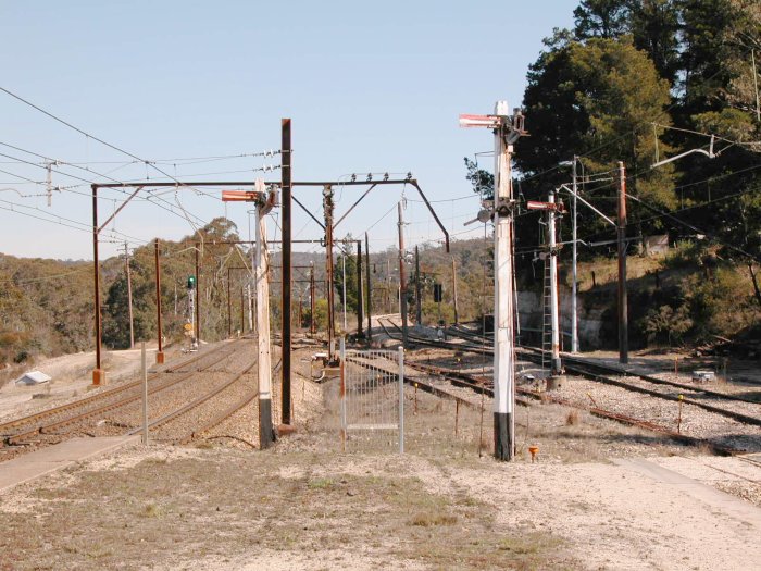 The view from the down end of the platform.  The two track on the left are the down and up main. The elevated track in the distance is the approach road for the Clarence Colliery, with the departure road visible at the right.