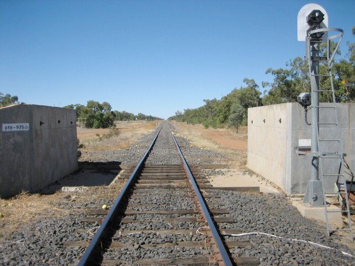 The Main Western line cuts through the town flood levy bank about 1km south of Nyngan station. This view, taken from the Nyngan side, shows the "long straight" running back towards Dubbo.