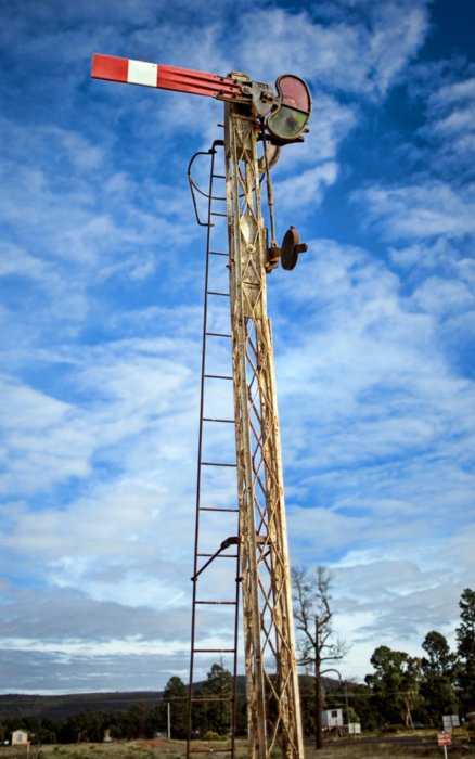 A sempahore signal on a lattice post is still present in the yard.