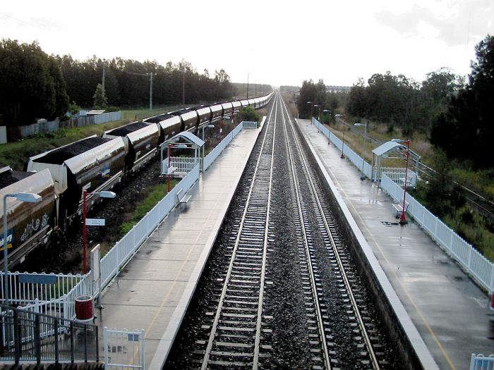 
A fully loaded coal train waits for the road on a rainy afternoon at Sandgate.
