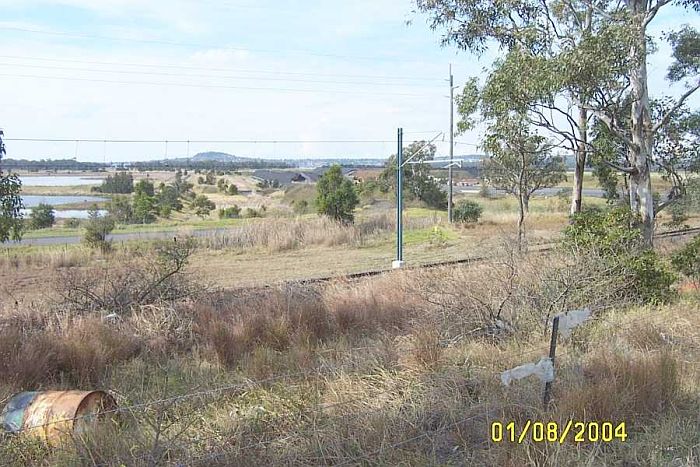 
The Branch left the main Line here, Just to the left of the metal post which
holds the electrified line you can see where it is being used as an access
road to the ash settling ponds which are to the right. It then turned back
to the left and crossed the centre of the photo. Where you can see a
concrete structure it then turned to the right and followed the embankment
straight down before again turning to the left.
