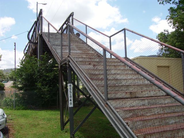 The footbridge at the Sydney end of the station provides a connection between two streets. The station is a single platform with street-level access. Note the metal plate used for the treads and risers.