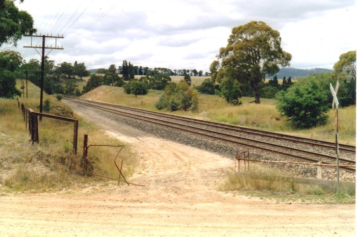 The site of Tarana Quarry Station looking towards Tarana. Note damaged railway gates.