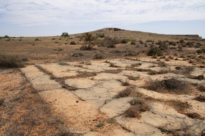 The base of a structure near the entrance to the yard.