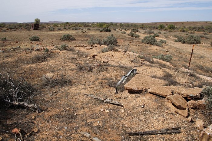 The base of one of several structures in the yard.