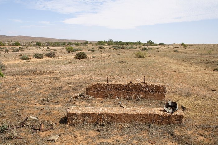 The base of a structure in the yard, looking towards end of the line.