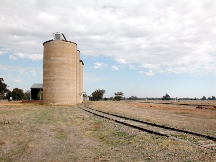 The view looking west looking along the silo siding.  The main line is on the right, with the white post being the location of the former station.