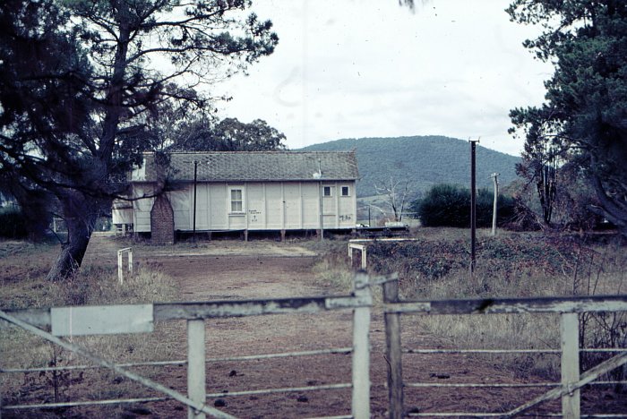 The rear of the station building.  Some graffiti on the building reads, "Tumba Railway + RIP".