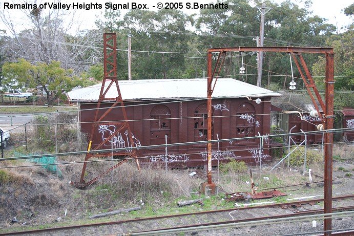 A view looking down through the overhead wires at what is left of the once 3 storey signal box beside the Down refuge loop and sidings at Valley Heights.