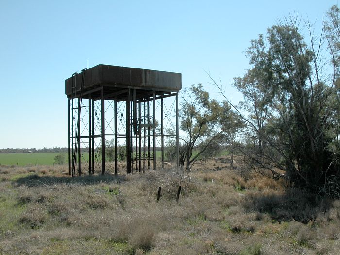 
The elevated water tank at the up end of the yard.  Visible behind the tree
in the centre is the turntable pit.  The engine shed was located in the bushed
on the right.
