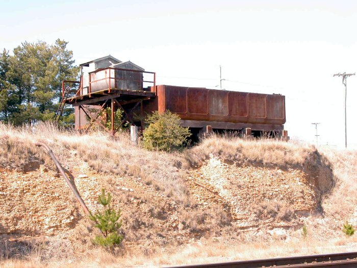 The elevated water tank and pump, at the up end of the yard.