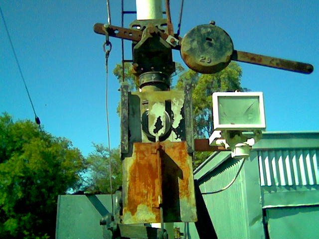 A worn "U" indicator on the base of a semaphore signal.