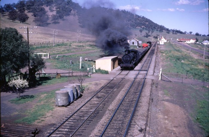 5242 heads No 239 Goods on its way north. The station can be seen in the distance onthe right hand side of the line.