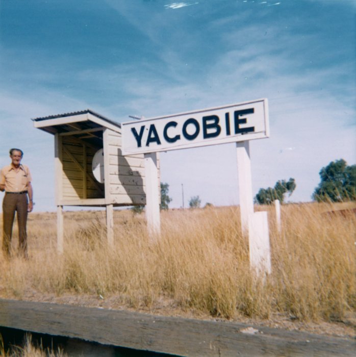 Fred Hood stands on the wooden-faced platform, still sporting its name board.